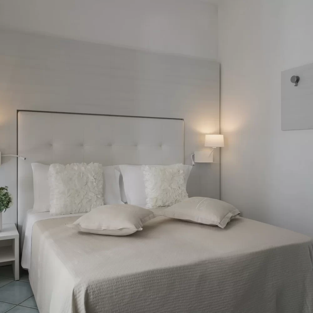 Modernes Schlafzimmer mit einem großen Bett, dekoriert in neutralen Tönen.